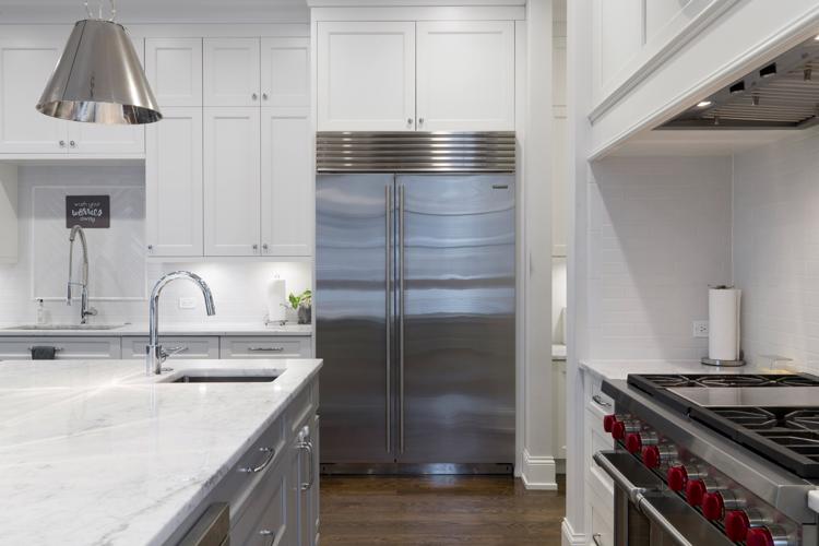 Free A sleek modern kitchen featuring stainless steel appliances and marble countertops. Stock Photo