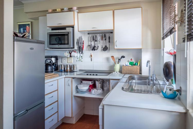 Free Sophisticated kitchen interior with modern appliances, wooden accents, and functional design. Stock Photo