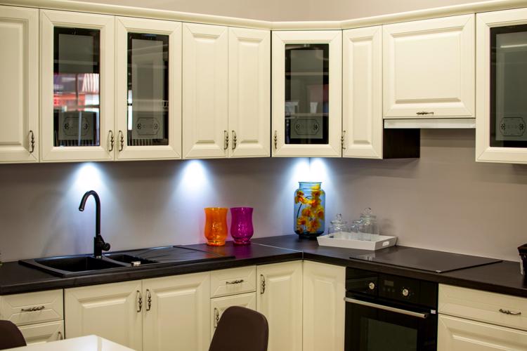 Free A stylish modern kitchen with white cabinets and colorful decor pieces. Stock Photo