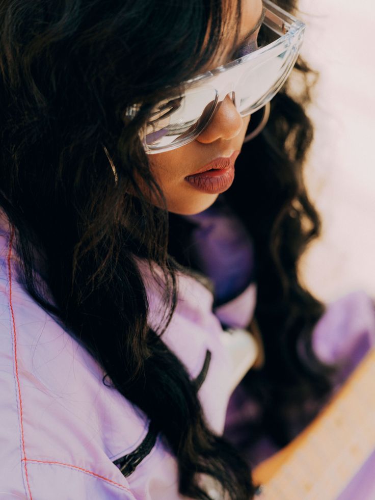 This may contain: a close up of a person wearing sunglasses