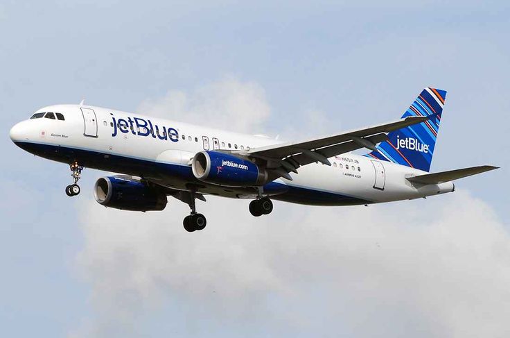 This may contain: a jetblue airplane is flying in the sky